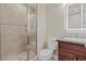 Bathroom with tiled shower and dark wood cabinets at 16 Via Visione # 101, Henderson, NV 89011