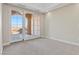 Bright bedroom with neutral colored carpet, recessed lighting, crown molding and outdoor access through French doors at 16 Via Visione # 101, Henderson, NV 89011