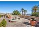 Outdoor terrace featuring a central fountain, manicured landscaping, and stunning views of the surrounding area at 16 Via Visione # 101, Henderson, NV 89011