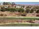 Picturesque golf course with mature trees and golfers enjoying the scenery at 16 Via Visione # 101, Henderson, NV 89011