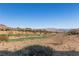 Expansive view of golf course with desert landscaping, distant homes and mountains at 16 Via Visione # 101, Henderson, NV 89011