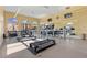 Bright gym with treadmills, elliptical machine, weights, and mirrored wall overlooking the outdoors at 16 Via Visione # 101, Henderson, NV 89011