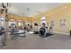 Well-lit gym with various exercise machines, including treadmills, ellipticals, and weight benches at 16 Via Visione # 101, Henderson, NV 89011