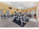 Bright gym with ample workout equipment, mirrored wall, and natural light from large windows at 16 Via Visione # 101, Henderson, NV 89011