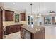 Spacious kitchen with granite counters, custom cabinetry, a wine cooler, and stainless appliances at 16 Via Visione # 101, Henderson, NV 89011