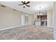 Open living room with tile floors, wine storage, pendant lighting, and stainless steel appliances in kitchen at 16 Via Visione # 101, Henderson, NV 89011