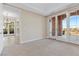 Main bedroom boasts French doors leading to outdoor space, neutral decor, and recessed lighting at 16 Via Visione # 101, Henderson, NV 89011