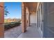 Outdoor patio with arches, ceiling fan, stone tile and sliding glass doors at 16 Via Visione # 101, Henderson, NV 89011