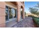 Arched patio with brick flooring, providing outdoor living space with desert views at 16 Via Visione # 101, Henderson, NV 89011