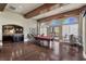 Open recreation room featuring a billiards table, bar seating, hardwood floors, and exposed beam ceiling at 16 Via Visione # 101, Henderson, NV 89011