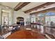 Expansive recreation room showcasing a billiards table, multiple seating areas, a bar, and hardwood floors at 16 Via Visione # 101, Henderson, NV 89011