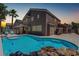 Private backyard featuring a sparkling pool, patio area, and mature palm trees, ideal for outdoor living at 1754 Quiver Point Ave, Henderson, NV 89012