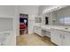 Bright bathroom with double sinks and views into the bedroom at 1754 Quiver Point Ave, Henderson, NV 89012