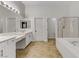 Bright bathroom featuring a soaking tub, double sinks, and separate shower at 1754 Quiver Point Ave, Henderson, NV 89012