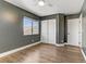 The bright bedroom features wood flooring, a closet, and crisp white trim at 1754 Quiver Point Ave, Henderson, NV 89012