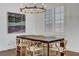 Dining room area showcasing modern decor, wood floors, a chandelier, and natural light at 1754 Quiver Point Ave, Henderson, NV 89012