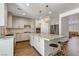 Bright kitchen with an island, granite countertops, modern light fixtures, and stainless steel appliances at 1754 Quiver Point Ave, Henderson, NV 89012