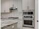 Modern kitchen featuring stainless steel appliances and decorative tile backsplash at 1754 Quiver Point Ave, Henderson, NV 89012