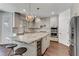 Modern kitchen featuring a large marble island, stainless steel appliances, and pendant lighting at 1754 Quiver Point Ave, Henderson, NV 89012