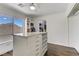 Large walk-in closet with a center island, custom shelving, and a bright window view at 1754 Quiver Point Ave, Henderson, NV 89012