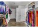 Spacious walk-in closet featuring custom shelves and hanging racks for organized storage and convenience at 1754 Quiver Point Ave, Henderson, NV 89012