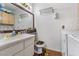 Bright bathroom featuring a single sink, ample counter space, and a laundry area at 1939 Dry Falls St, Las Vegas, NV 89142