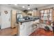 Well-equipped kitchen with breakfast bar, sleek countertops, light cabinetry, and practical appliances at 1939 Dry Falls St, Las Vegas, NV 89142