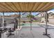 Covered patio with outdoor dining area overlooking the pool at 1939 Dry Falls St, Las Vegas, NV 89142