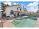 Sparkling pool with steps, patio area with chairs, and a well-maintained yard at 1939 Dry Falls St, Las Vegas, NV 89142