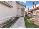 A well maintained side entrance featuring a walkway lined with artificial turf at 1939 Dry Falls St, Las Vegas, NV 89142