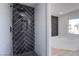 Modern bathroom featuring a sleek shower with stylish black herringbone tile and a luxurious soaking tub at 2032 Jesse Scott St, Las Vegas, NV 89106