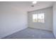 This bright, neutral bedroom offers plush carpet and a sun-filled window at 2032 Jesse Scott St, Las Vegas, NV 89106