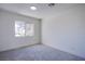 This bright, neutral bedroom offers plush carpet and a sun-filled window at 2032 Jesse Scott St, Las Vegas, NV 89106