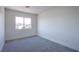 This bright, neutral bedroom offers plush carpet and a sun-filled window at 2032 Jesse Scott St, Las Vegas, NV 89106