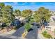 Inviting street view of a gated community entrance with mature trees and lush landscaping at 2032 Jesse Scott St, Las Vegas, NV 89106