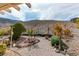 This landscaped backyard features desert landscaping and mountain views at 2035 King Mesa Dr, Henderson, NV 89012