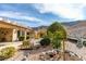 The backyard includes a patio, desert landscaping, and mountain views at 2035 King Mesa Dr, Henderson, NV 89012