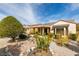 This backyard shows desert landscaping with decorative bushes and gravel at 2035 King Mesa Dr, Henderson, NV 89012