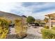 This backyard shows desert landscaping with decorative trees, bushes, and rock at 2035 King Mesa Dr, Henderson, NV 89012