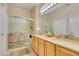 Bathroom featuring a double sink vanity and shower-tub combination with glass doors at 2035 King Mesa Dr, Henderson, NV 89012