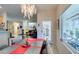 Open concept dining room with decorative chandelier and view into the living room and backyard at 2035 King Mesa Dr, Henderson, NV 89012