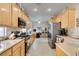 Spacious kitchen featuring wood cabinets, stainless steel appliances, and an adjoining office space at 2035 King Mesa Dr, Henderson, NV 89012