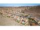 An aerial view showcases a desert neighborhood surrounded by mountain with sidewalks and mature landscaping at 2035 King Mesa Dr, Henderson, NV 89012