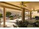 This covered patio features a ceiling fan, desert landscaping, and mountain views at 2035 King Mesa Dr, Henderson, NV 89012