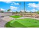 This backyard features an immaculate putting green and wrought iron fence overlooking a golf course at 2160 Pueblo Cir, Las Vegas, NV 89169