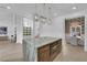 Modern kitchen with a large island, stainless steel appliances, and an open view of the dining area at 2160 Pueblo Cir, Las Vegas, NV 89169