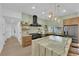 Bright kitchen featuring a marble waterfall island, stainless steel appliances, and open shelving with decor at 2160 Pueblo Cir, Las Vegas, NV 89169