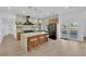 Modern kitchen with stainless steel appliances, granite countertop island, and decorative pendant lighting at 2160 Pueblo Cir, Las Vegas, NV 89169