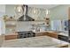 Modern kitchen featuring open shelving, statement lighting, a marble countertop, and stainless steel appliances at 2160 Pueblo Cir, Las Vegas, NV 89169