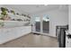 Bright laundry room with white cabinets, quartz countertops, and access to the backyard at 2160 Pueblo Cir, Las Vegas, NV 89169